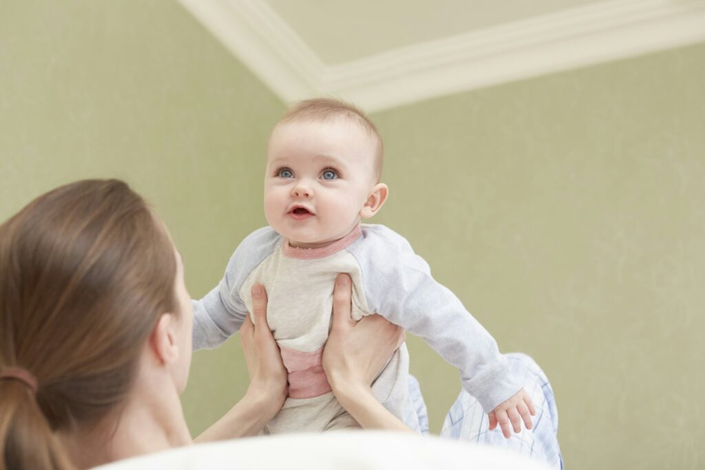 Women holding up baby daughter